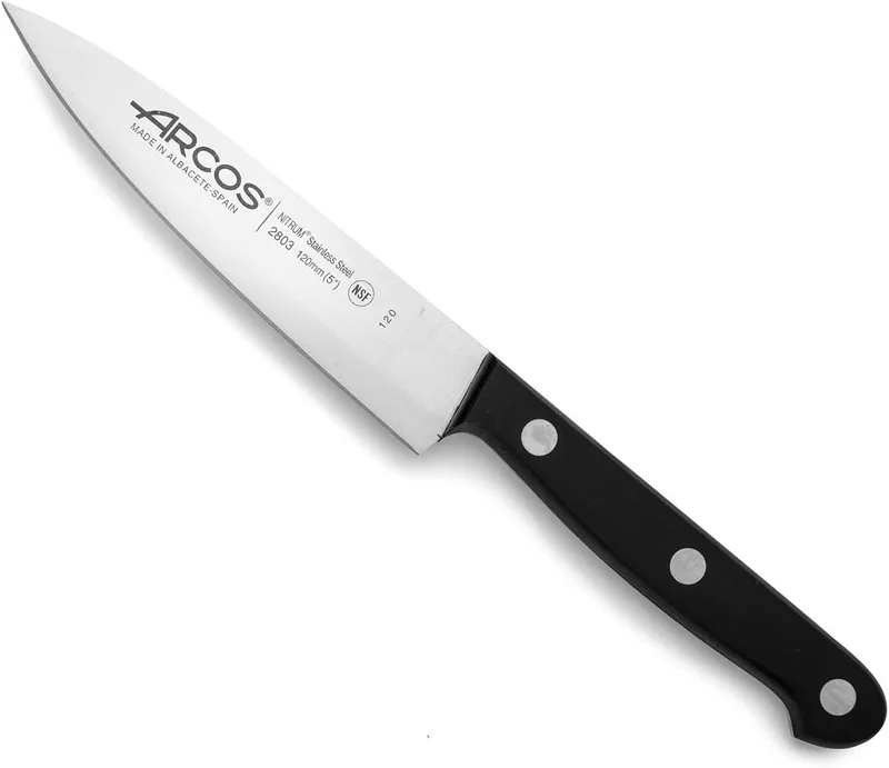 Arcos ▫️ Faca Chef em aço inoxidável. Faca de cozinha para cortar e descascar alimentos pequenos. Cabo ergonómico em polioximetileno. Lâmina de 120 mm. Série universal. Cor preta.