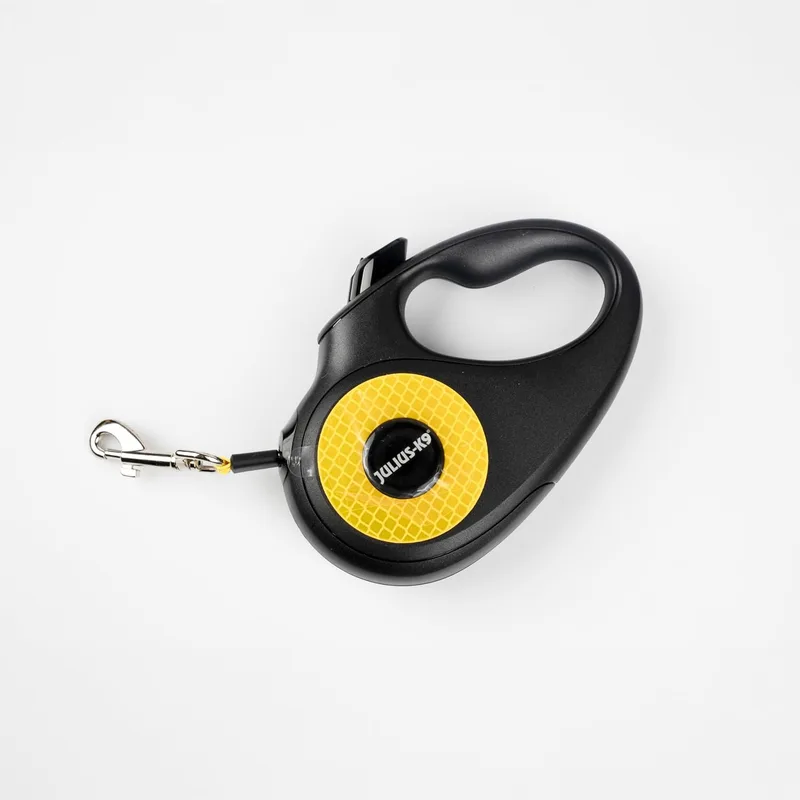Julius-K9 ▫️ Trela retrátil para cães tamanho S – fita de 5 m, preta/laranja – pega antiderrapante, trela em fita, extensível, travão com uma só mão, pausa, bloqueio, fita refletora, não se enrola, resistente